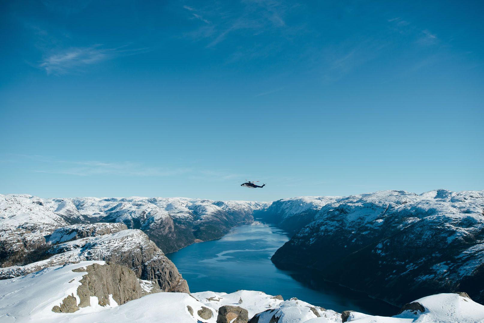 Rescue helicopter over a Norwegian fjord in winter